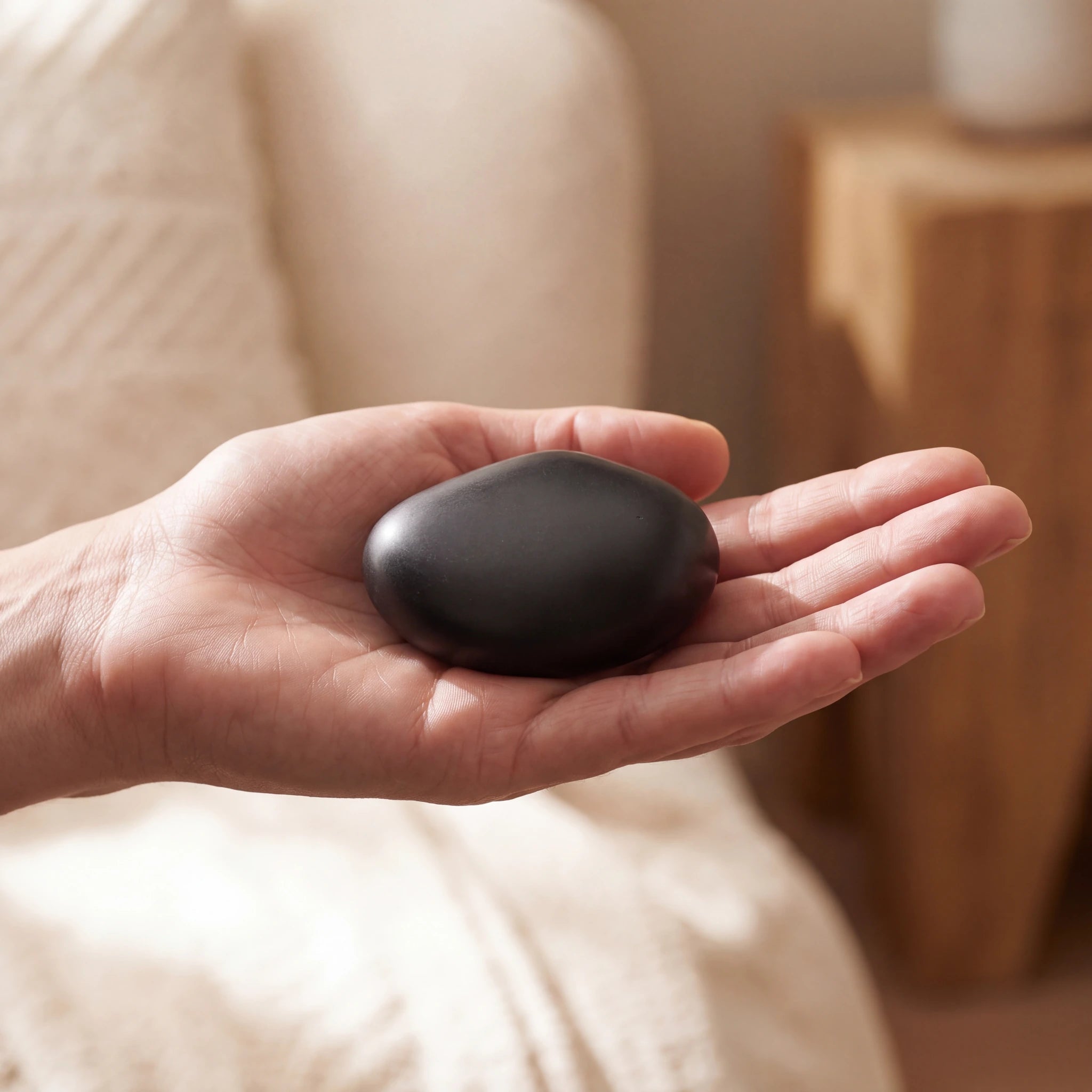 Palm-Stone-Small-Urn-for-Ashes-in-Matte-Black-In-the-Palm