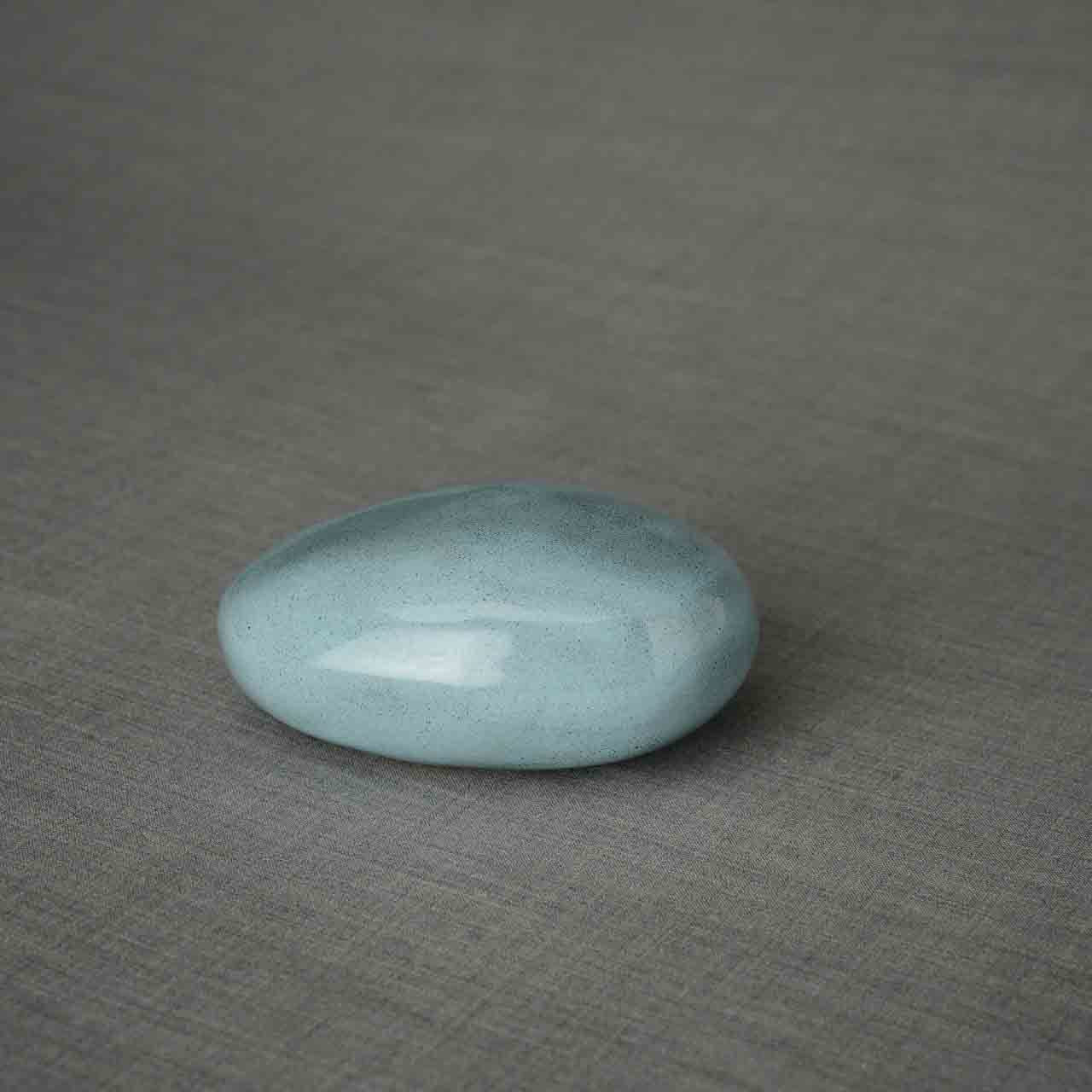 Pebbles Ashes Keepsake Urn in Light Blue Facing Left Dark Background