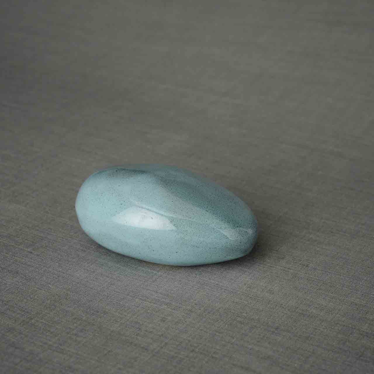 Pebbles Ashes Keepsake Urn in Light Blue Facing Right Dark Background
