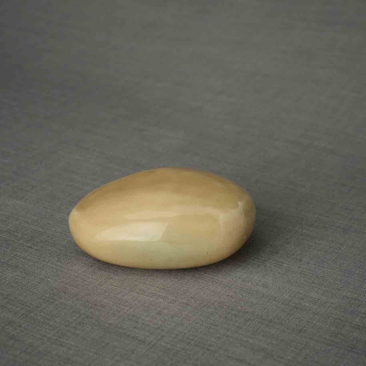 Pebbles Ashes Keepsake Urn in Light Sand Dark Background