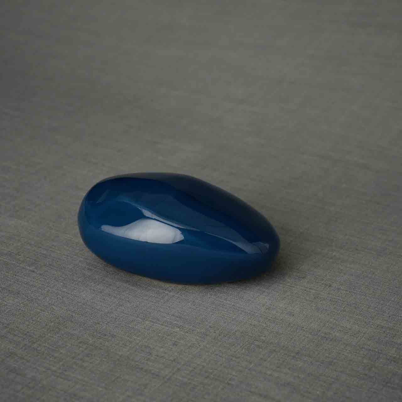 Pebbles Ashes Keepsake Urn in Metallic Blue Facing Right Dark Background