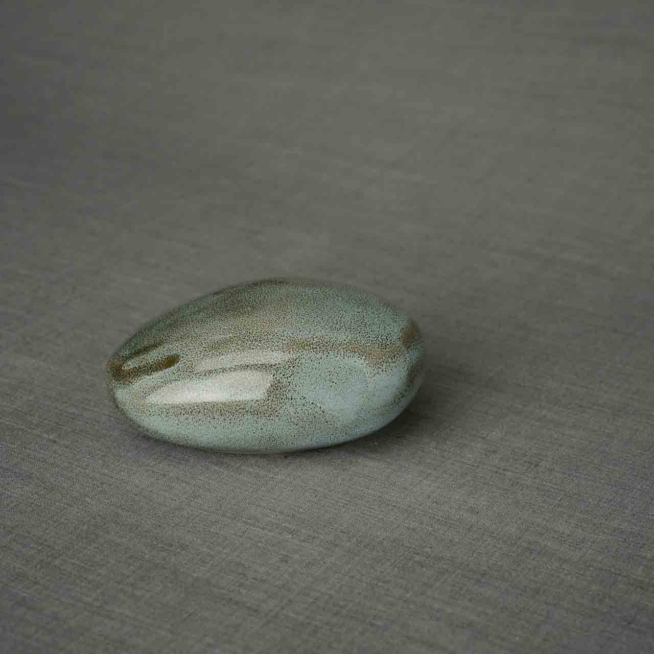 Pebbles Ashes Keepsake Urn in Oily Green Dark Background