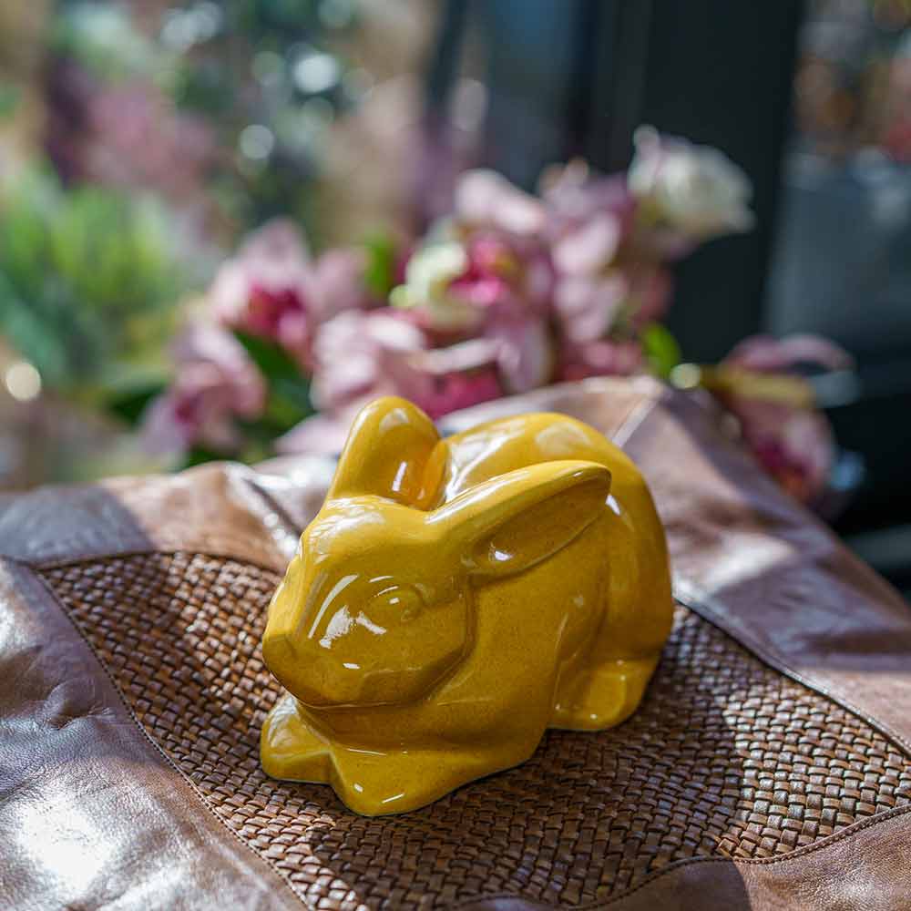 Rabbit Urn For Ashes Amber On Cushion Front Left Facing