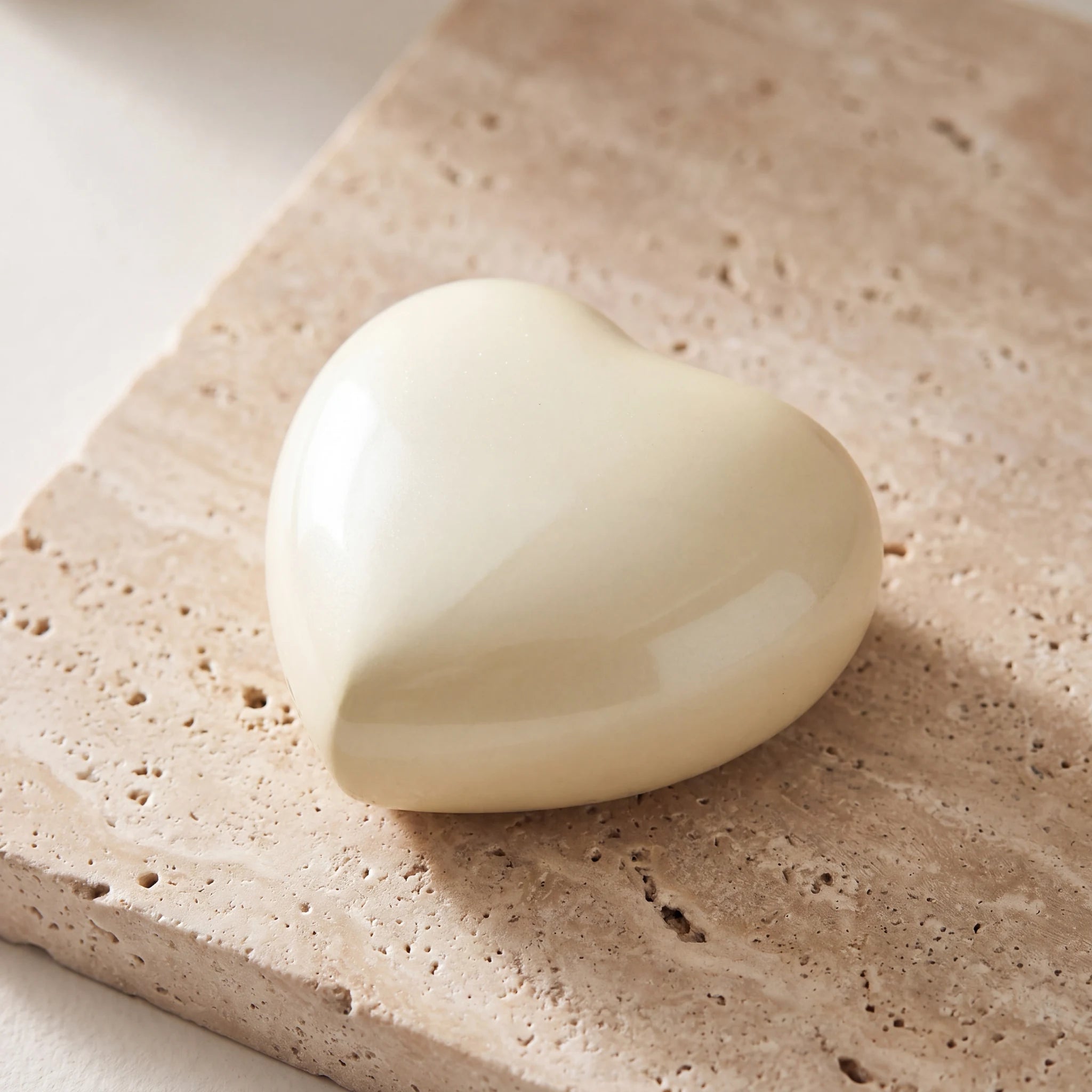 Satori-Metal-Heart-Keepsake-Urn-for-Ashes-in-Pearl-Yellow-On-Travertine