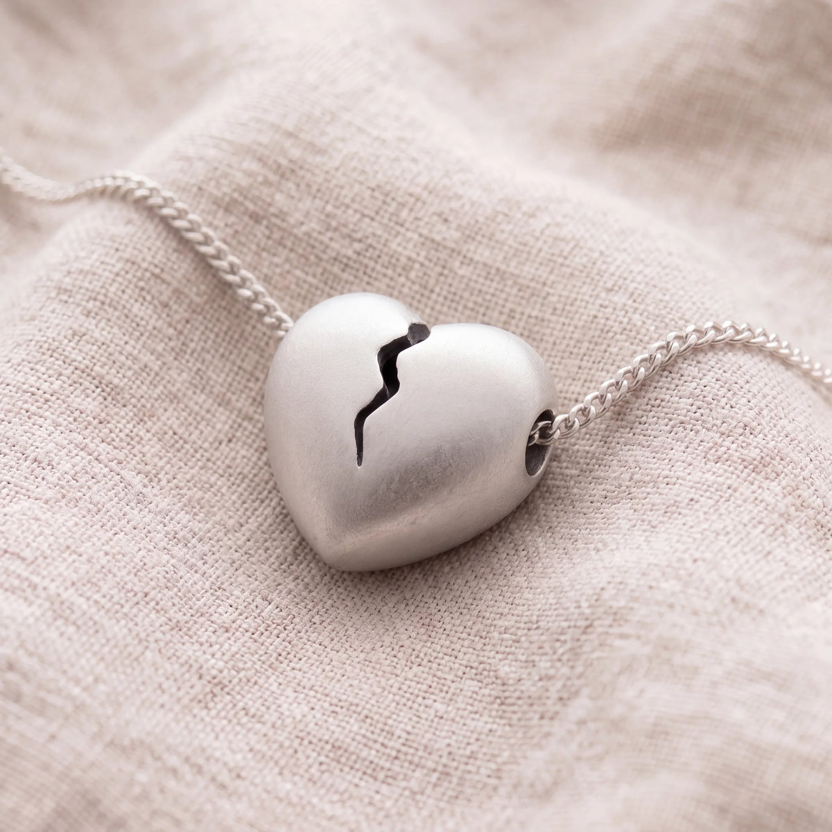 Self-fill-Heartbreak-Memorial-Ashes-Pendant-On-Linen