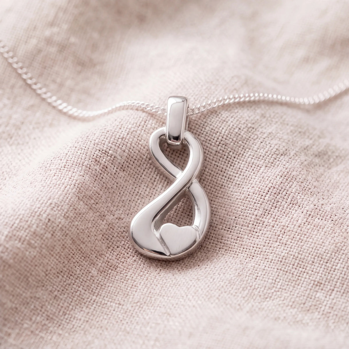 Self-fill-Infinity-Heart-Memorial-Ashes-Pendant-On-Linen