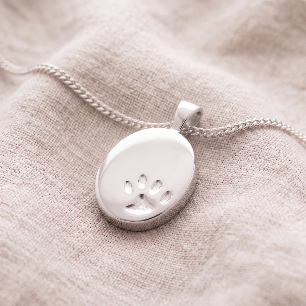 Self-fill-Paw-Print-Memorial-Ashes-Pendant-On-Linen