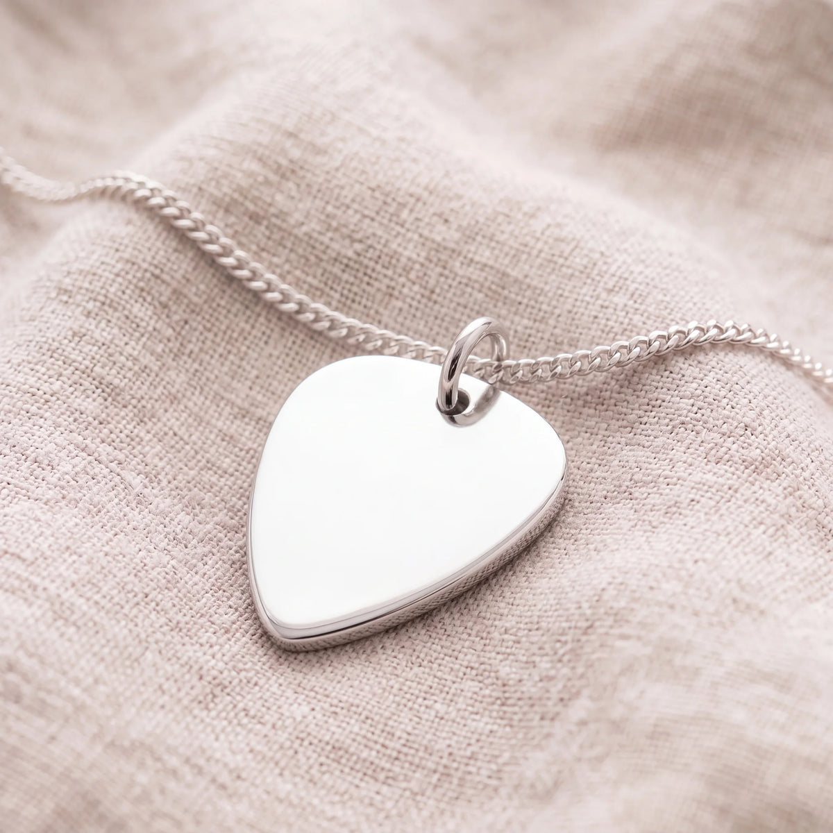 Self-fill-Plectrum-Memorial-Ashes-Pendant-On-Linen