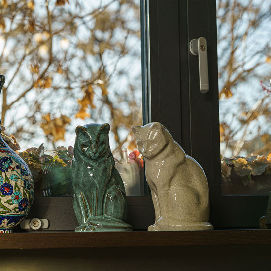 Sitting Cat Cremation Urn For Ashes Oily Green And Crackle Glaze Infront Window Day Light