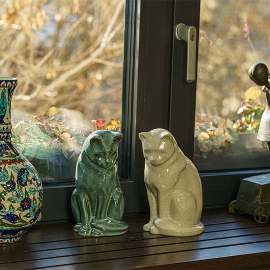 Sitting Cat Cremation Urn For Ashes Oily Green And Crackle Glaze Near Vase Together Day Light