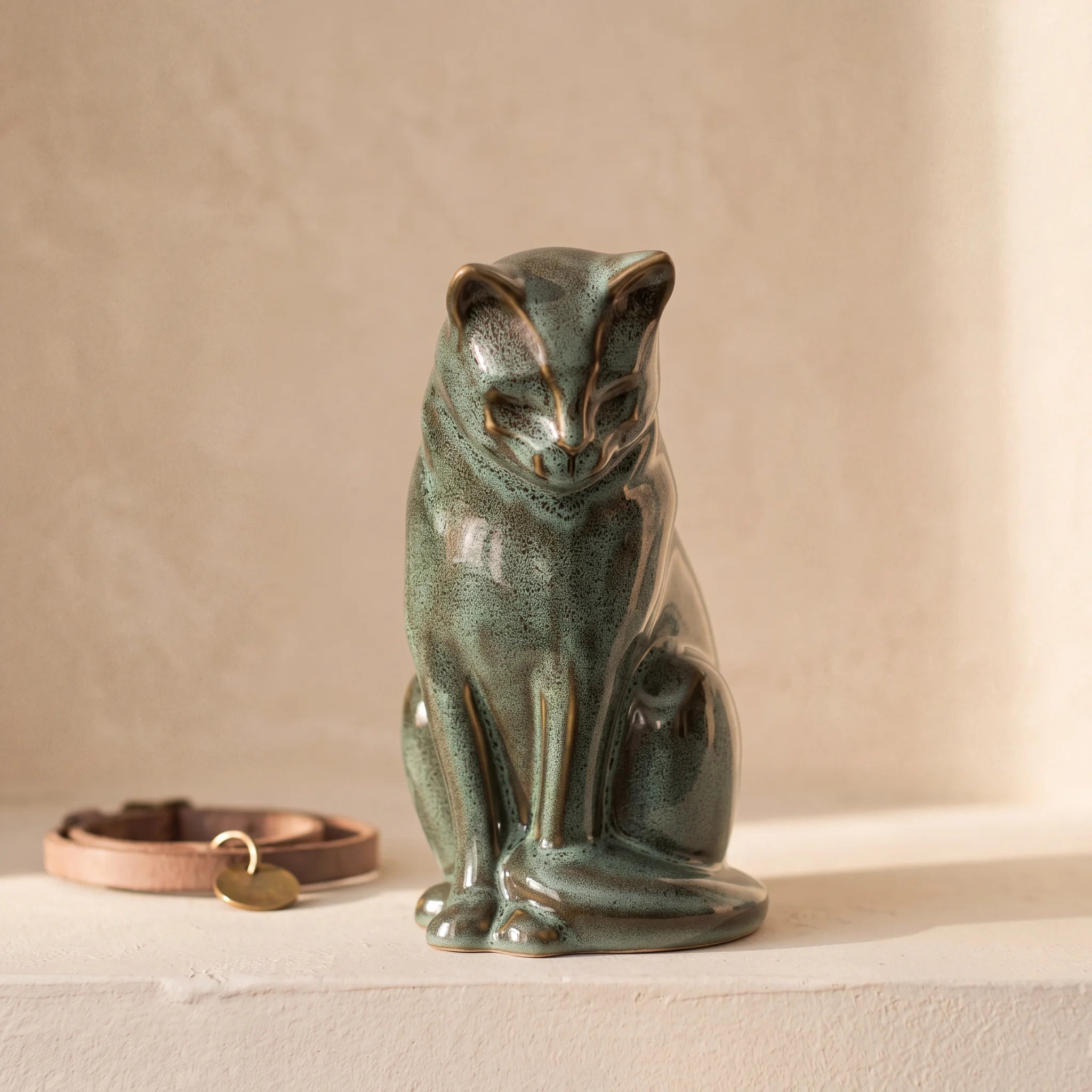 Sitting-Cat-Urn-for-Ashes-in-Oily-Green-pet_collar_ledge