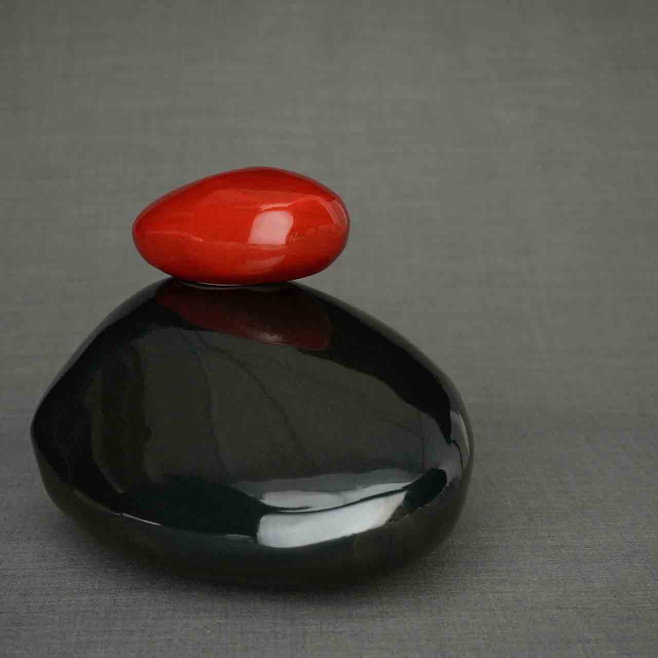 Stone Cremation Urn for Ashes in Glossy Black and Red Facing Right Grey Background