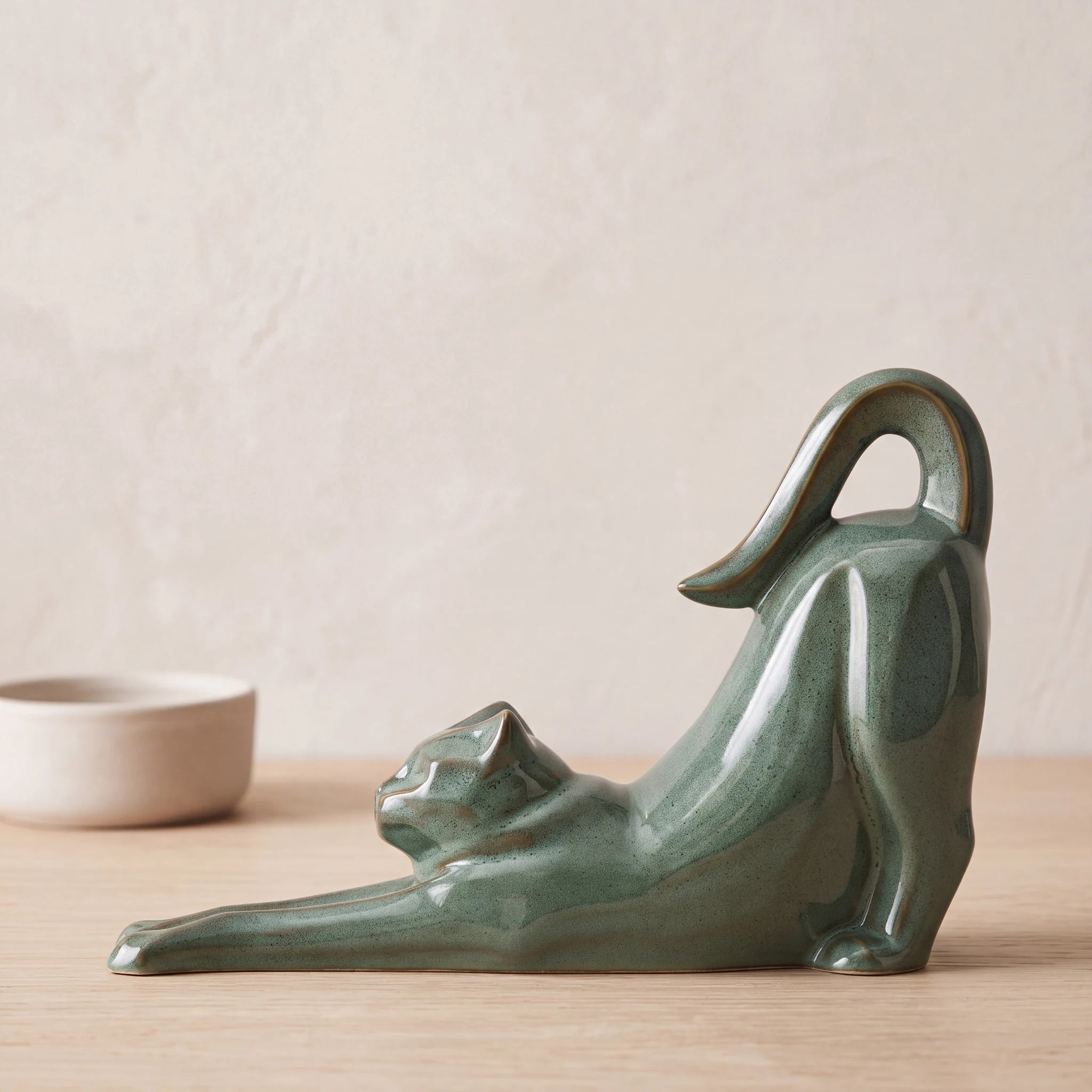 Stretching-Cat-Urn-for-Ashes-in-Oily-Green-pet_bowl_ledge