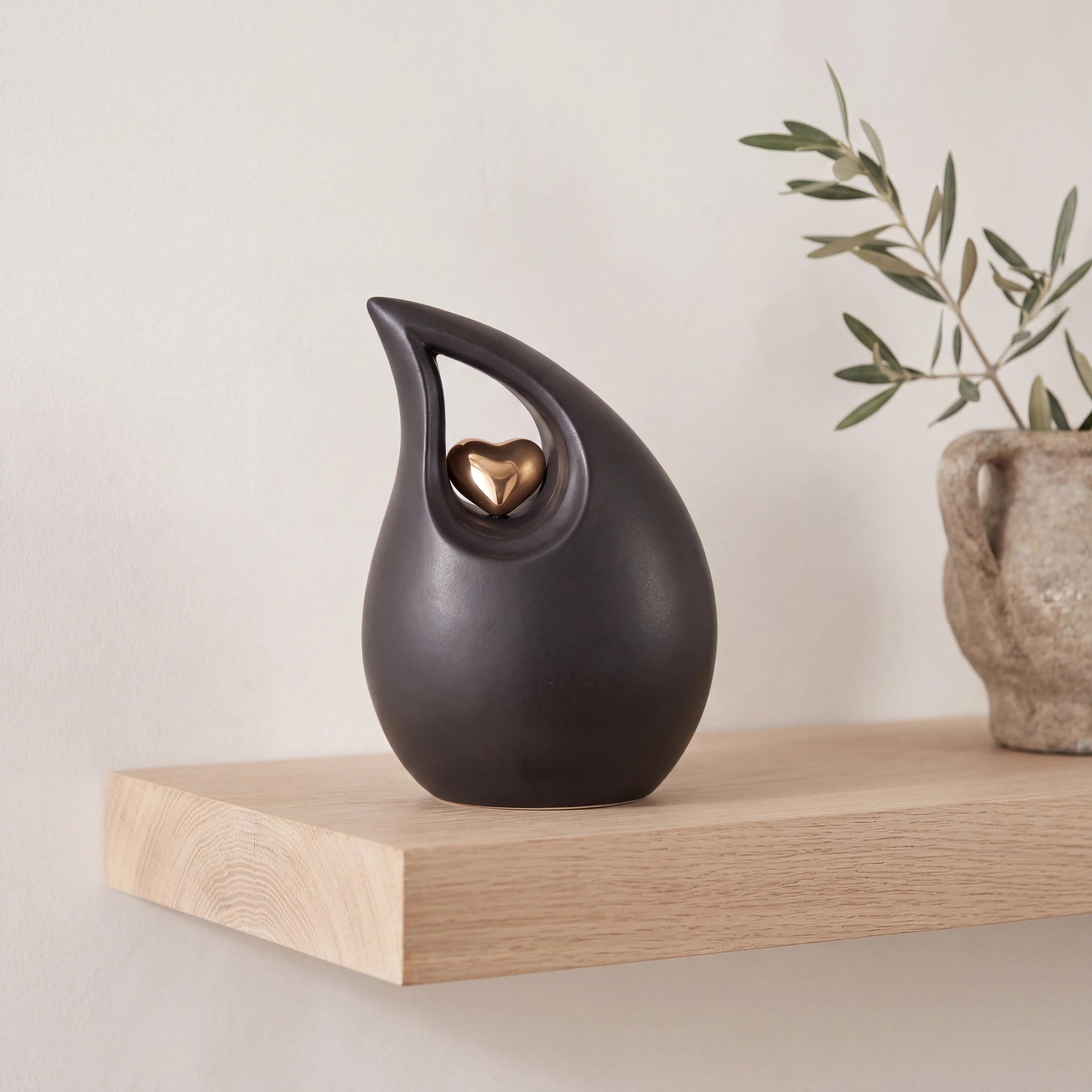 Teardrop-Heart-Medium-Urn-for-Ashes-in-Black-and-Gold-Oak-Shelf