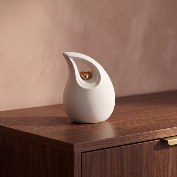Teardrop-Heart-Small-Urn-for-Ashes-in-White-and-Gold-Walnut-Sideboard