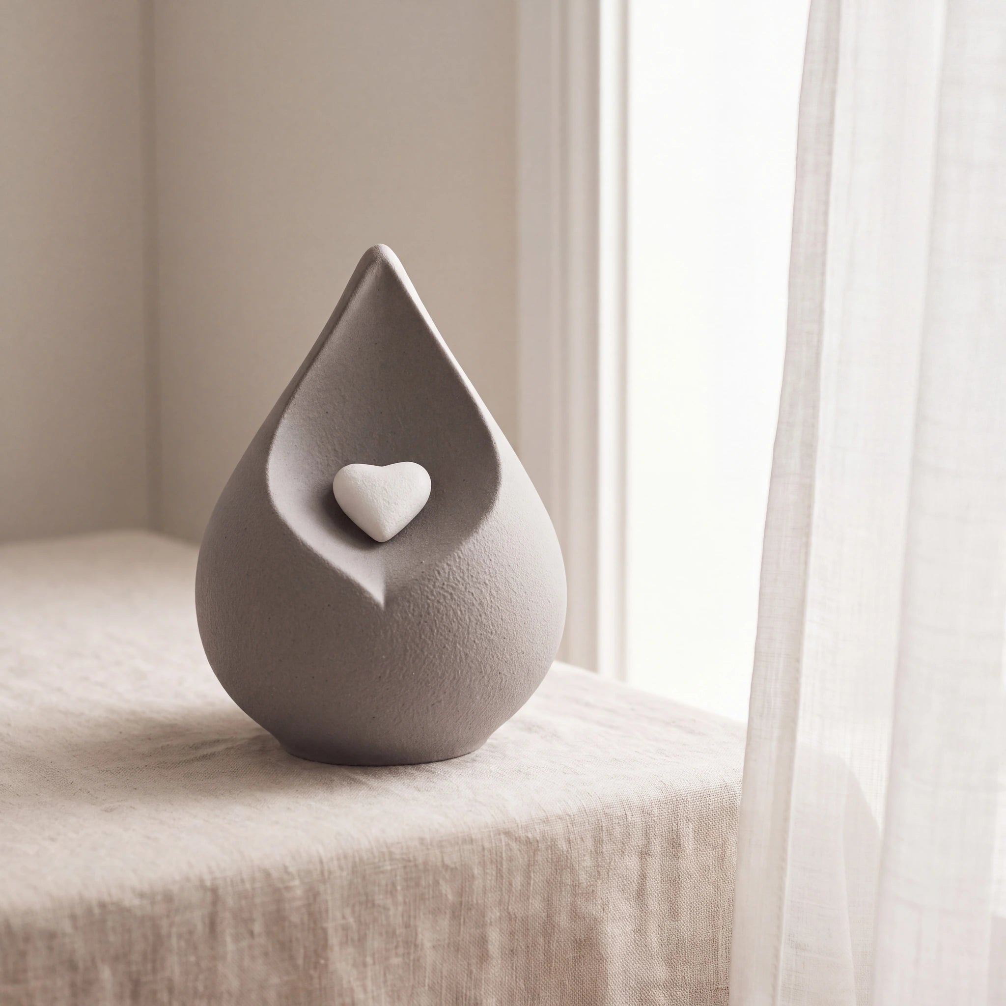 Teardrop-Small-Urn-for-Ashes-in-with-Heart-in-Grey-Linen-Table