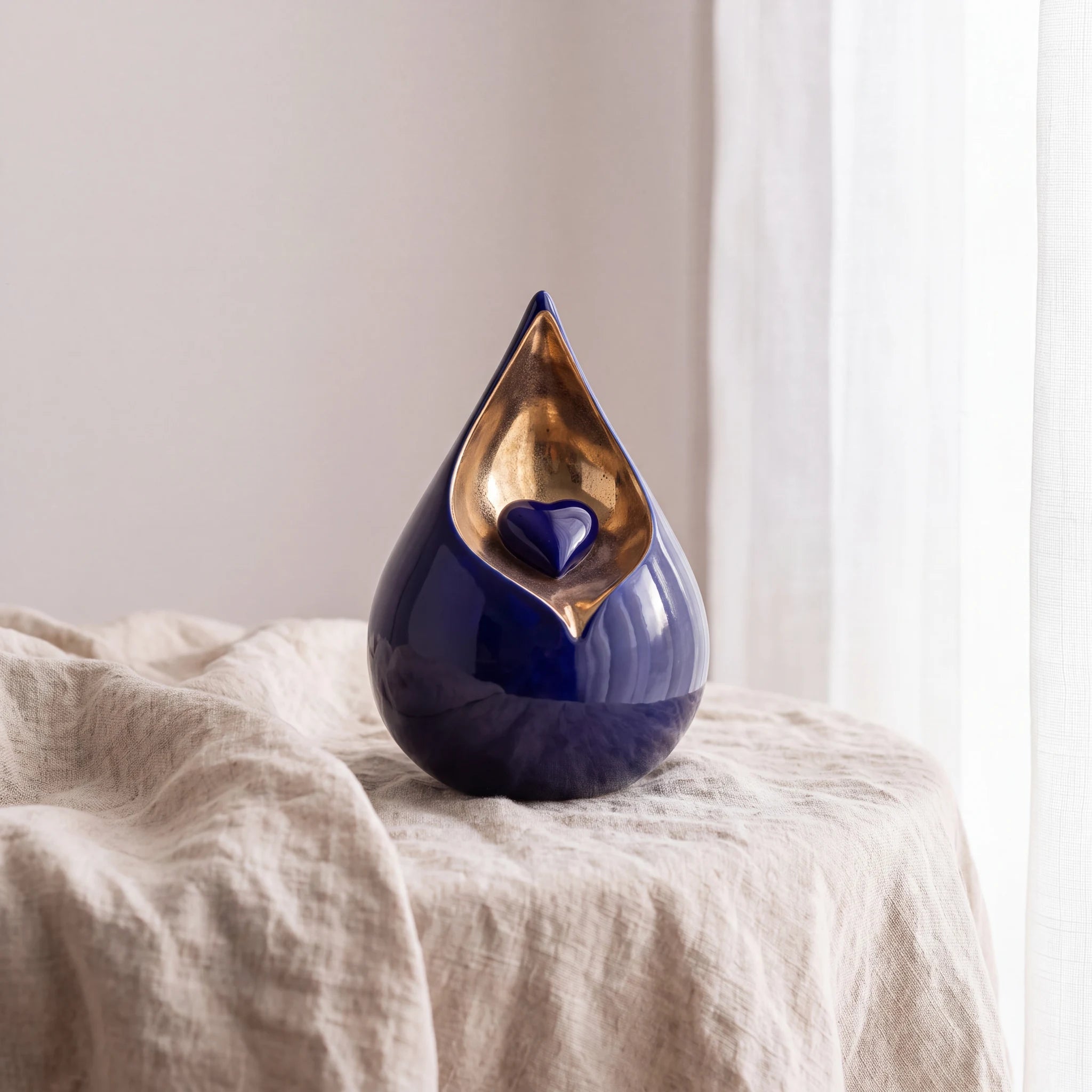 Teardrop-Small-Urn-for-with-Heart-Ashes-in-Cobalt-Blue-and-Gold-Linen-Table