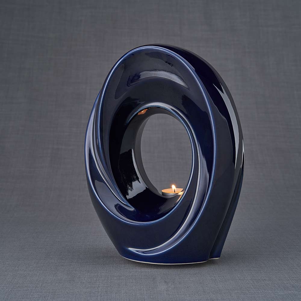 The Passage Cremation Urn for Ashes in Metallic Blue Turned Left Dark Background