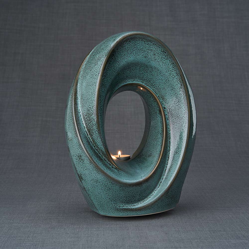 The Passage Cremation Urn for Ashes in Oily Green Turned Right Dark Background
