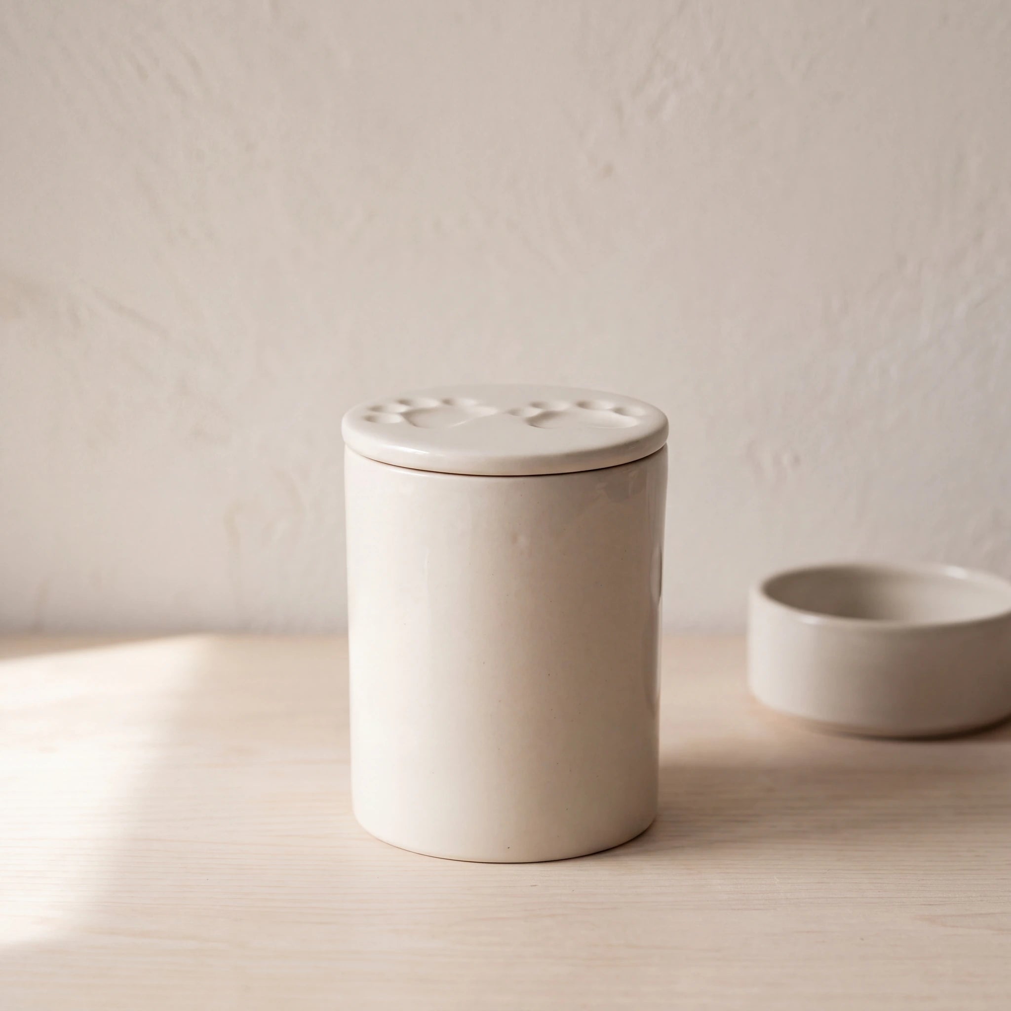 Two-Paws-Pet-Urn-for-Ashes-in-Cream-pet_bowl_ledge