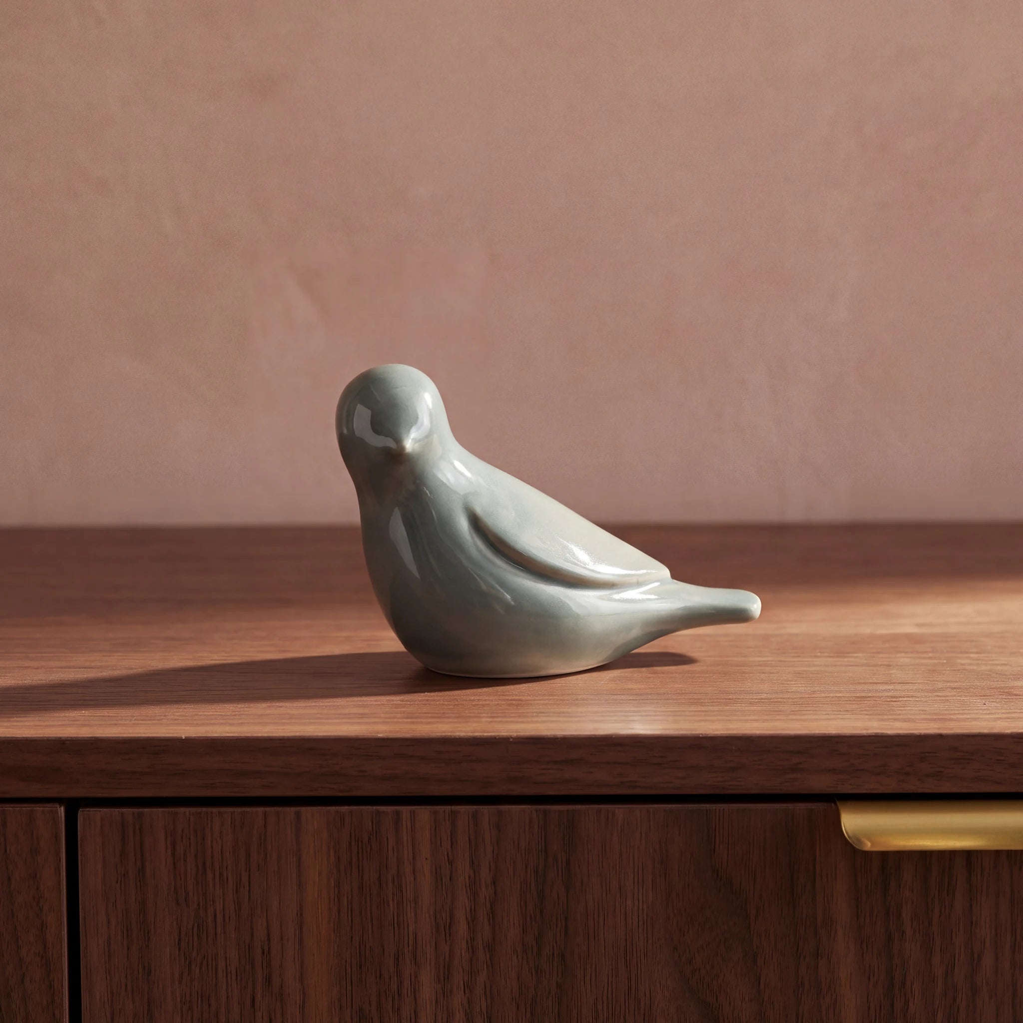 Whistling-Bird-Keepsake-Urn-for-Ashes-in-Sage-Green-Walnut-Sideboard