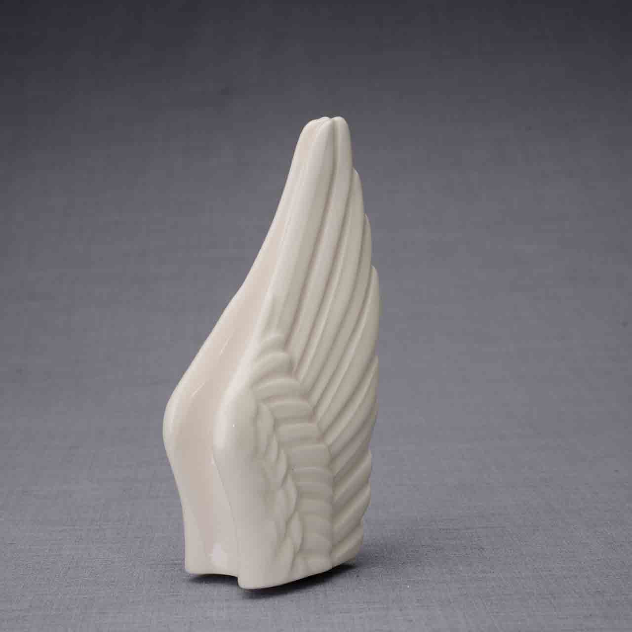 Wings Ashes Keepsake Urn in Cream Turned Right Dark Background