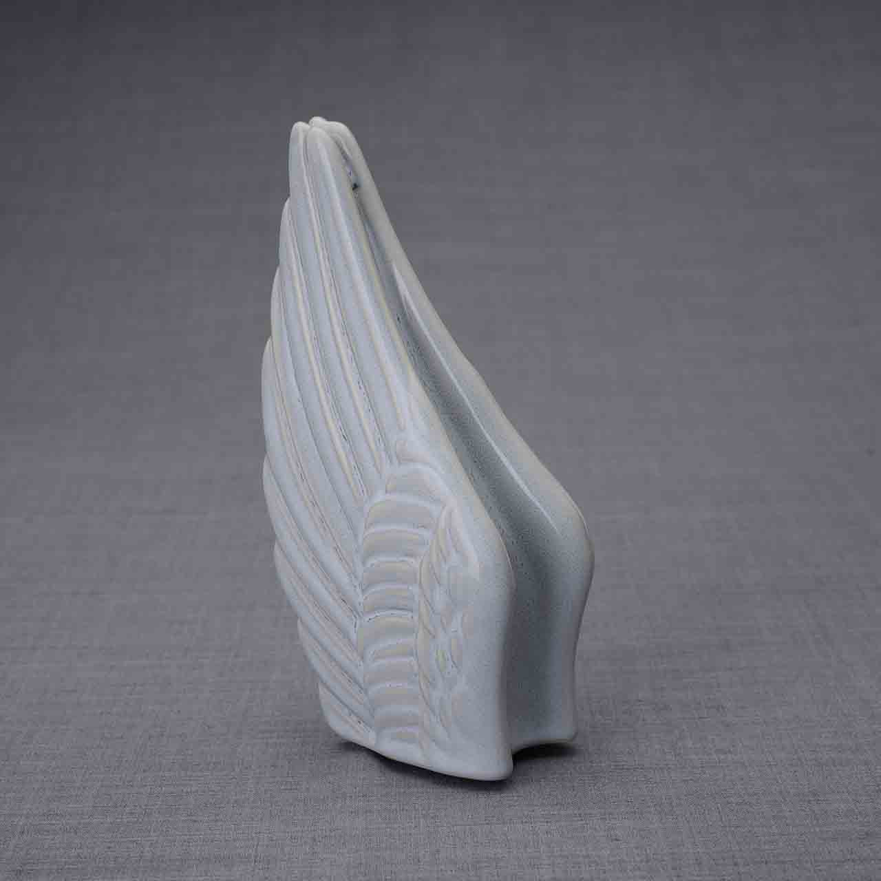 Wings Ashes Keepsake Urn in Grey Turned Left Dark Background