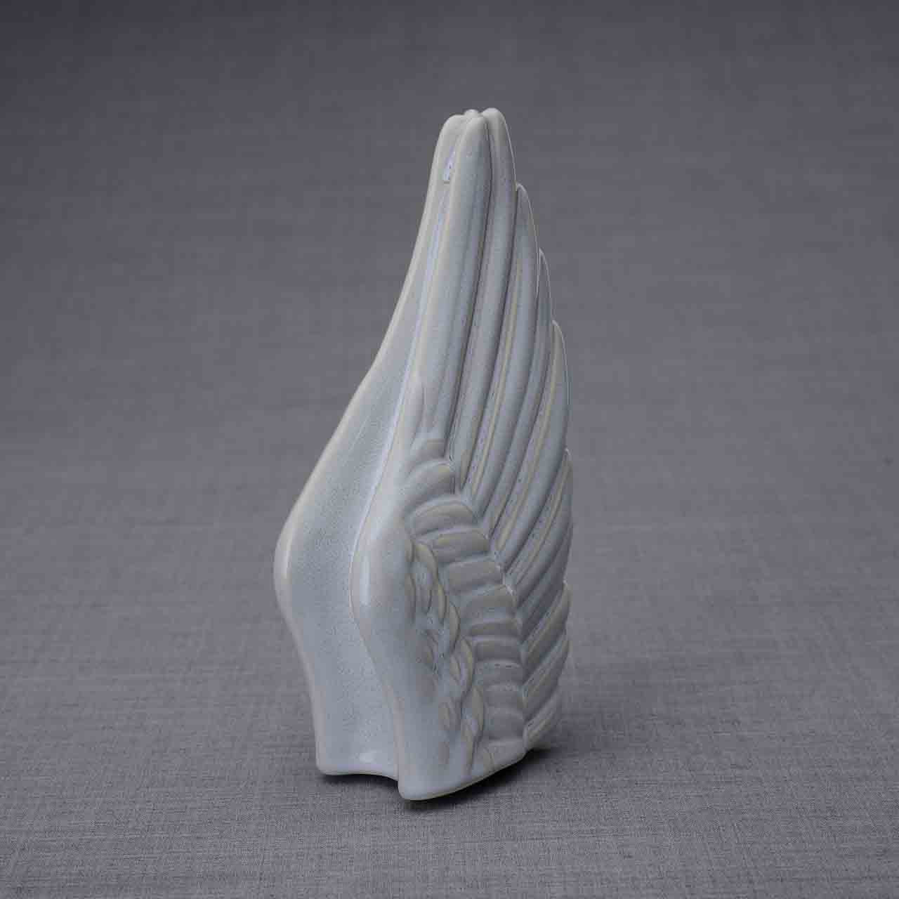 Wings Ashes Keepsake Urn in Grey Turned Right Dark Background