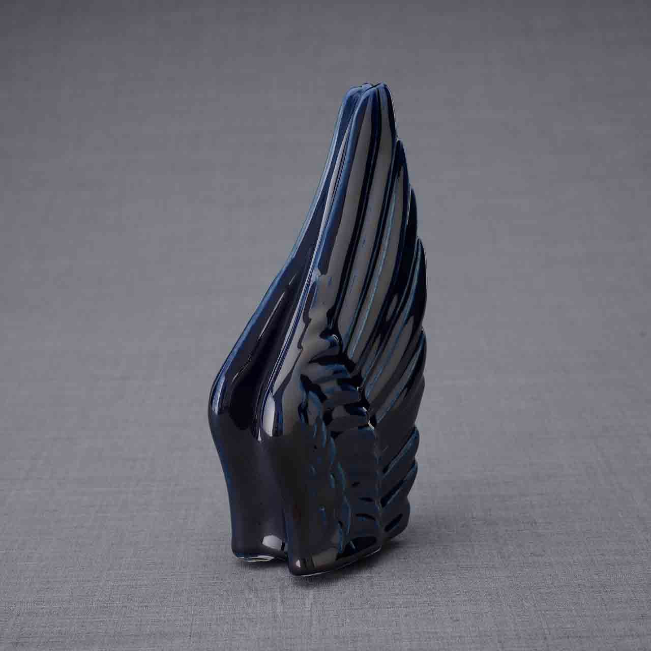 Wings Ashes Keepsake Urn in Metallic Blue Turned Right Dark Background