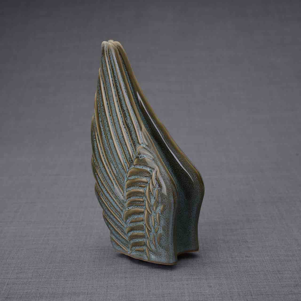 Wings Ashes Keepsake Urn in Oily Green Turned Left Dark Background