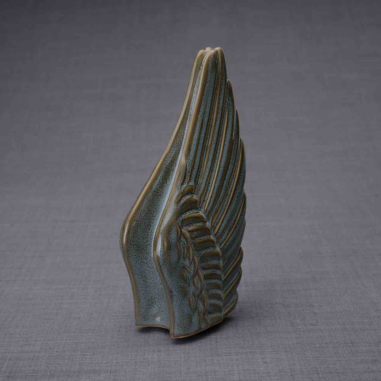Wings Ashes Keepsake Urn in Oily Green Turned Right Dark Background