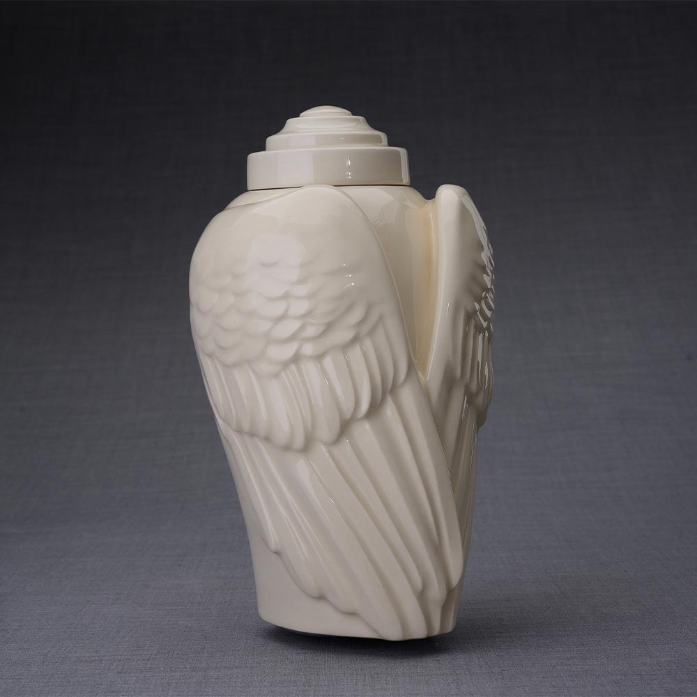 Wings Cremation Urn for Ashes in Cream Turned Right Dark Background
