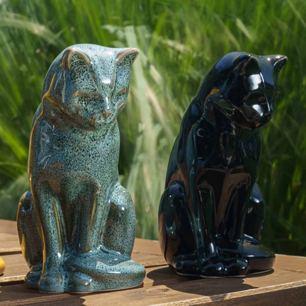 Cat Urns For Ashes Outside Oily Green And Glossy Black Next To Each Other