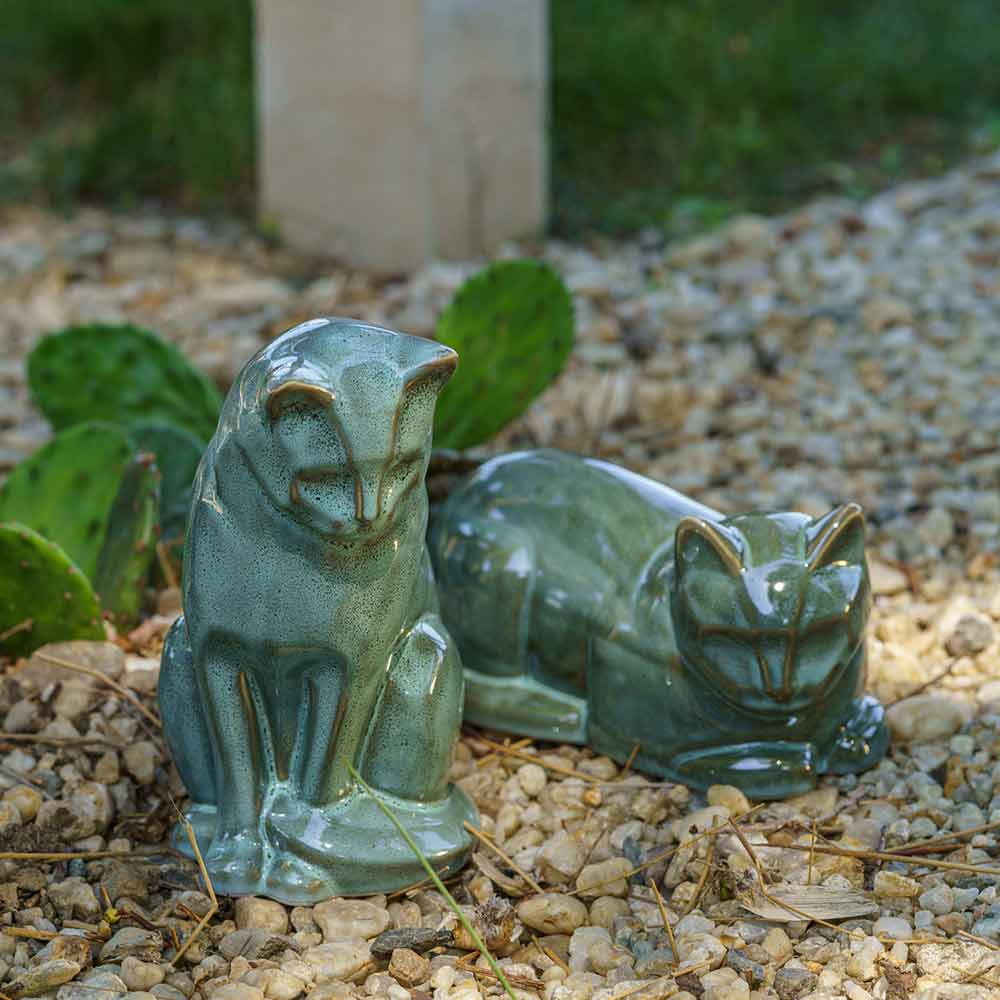 Oily Green Cat Urns For Ashes Outside Sitting And Lying On Stones