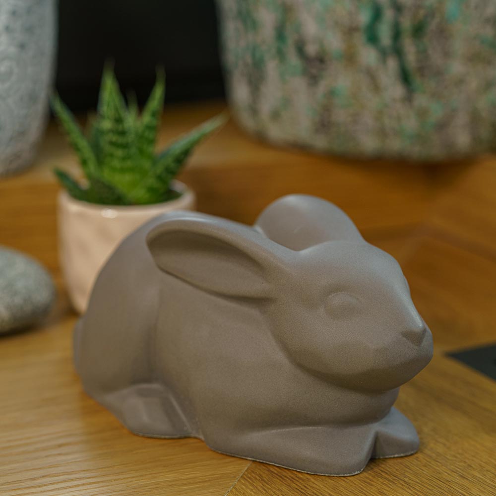 Rabbit Urn For Ashes Matte Grey On Cupboard Front Right