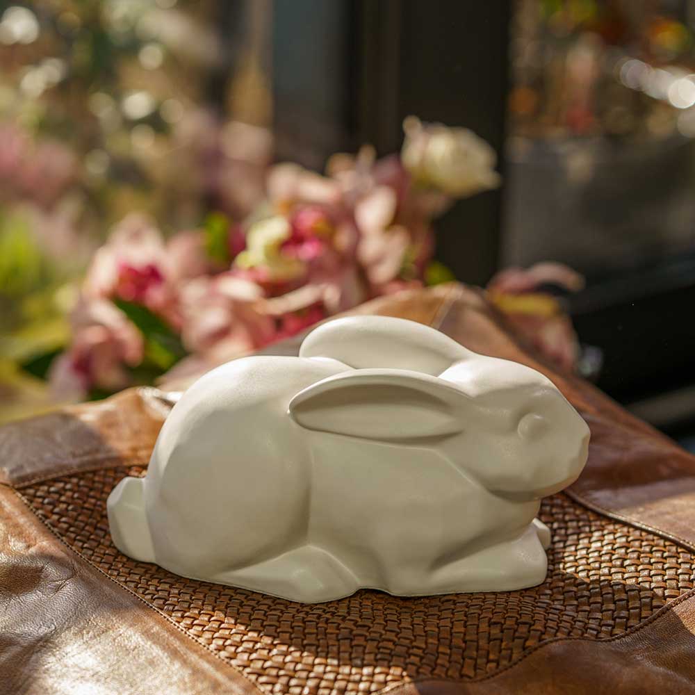 Rabbit Urn For Ashes Matte White On Leather Cushion Right