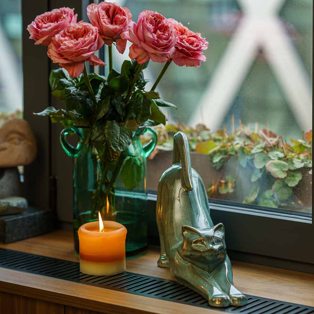 Stretching Cat Urn For Ashes Oily Green On Window Ledge With Flowers Right