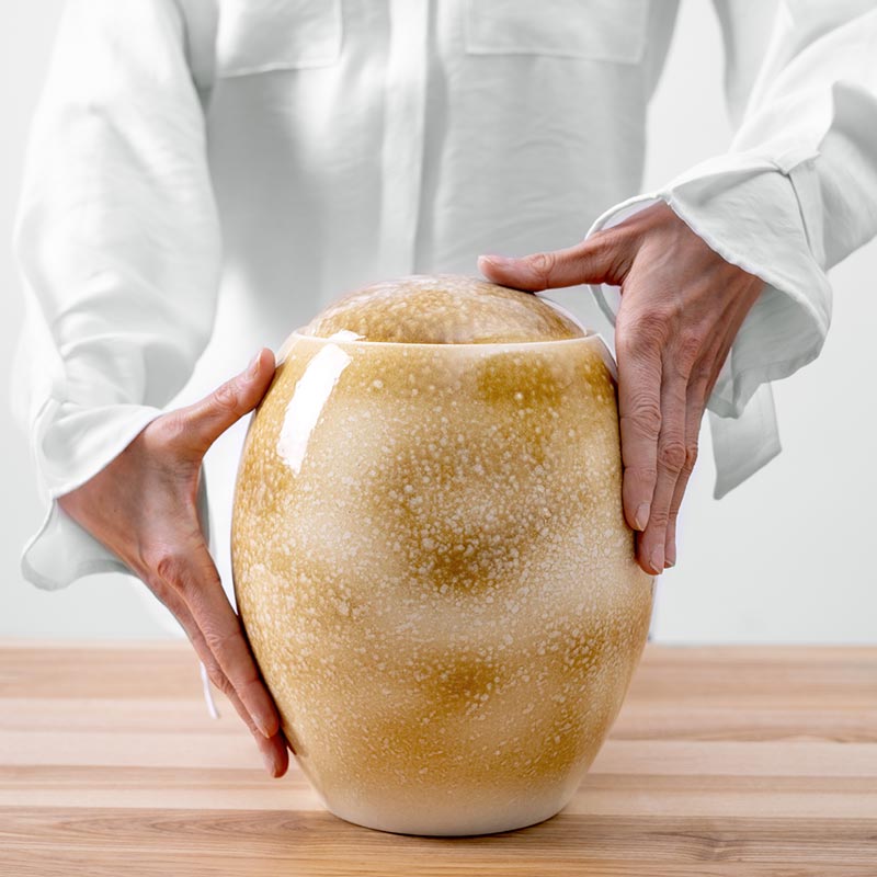 Amber Modern Cremation Urn for Ashes Being Held