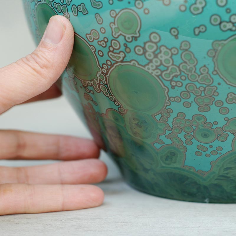 Emerald Cremation Urn for Ashes Close Up with Hand