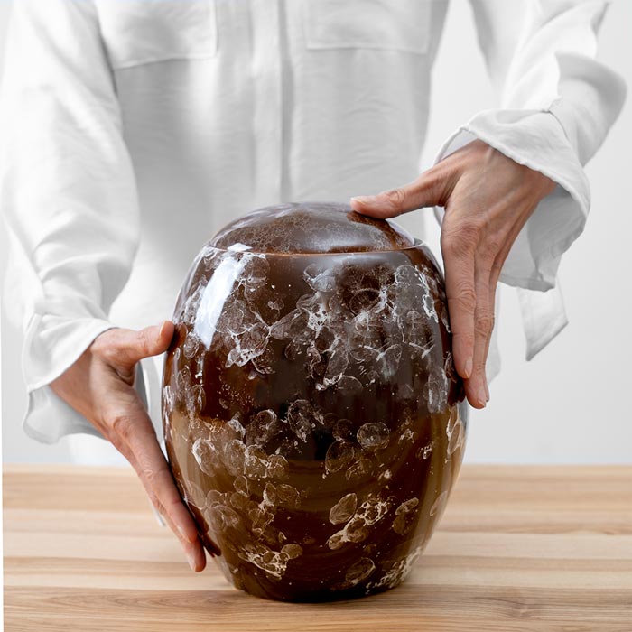 Freckled Modern Cremation Urn for Ashes Brown Being Held