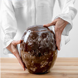 Freckled Modern Cremation Urn for Ashes Brown Being Held