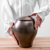Gold Classic Cremation Urn for Ashes Being Held