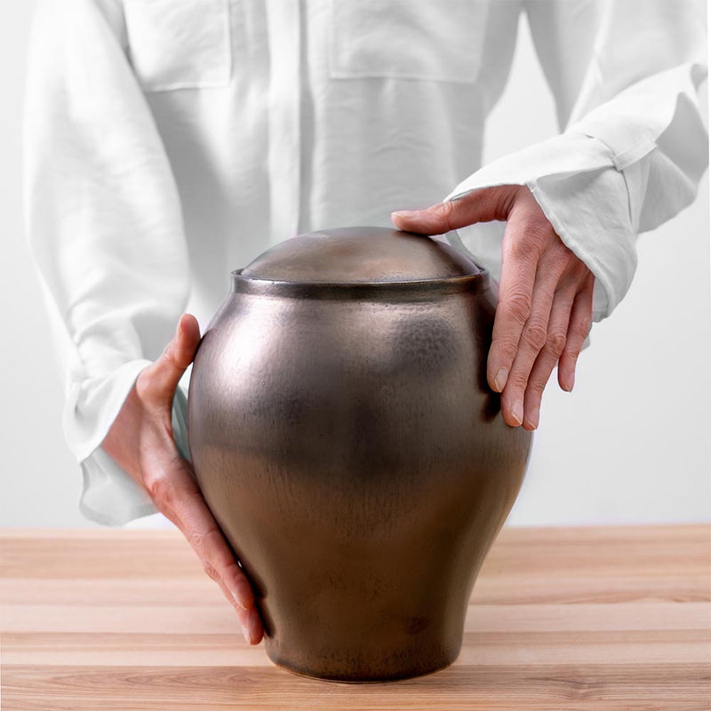 Gold Classic Cremation Urn for Ashes Being Held