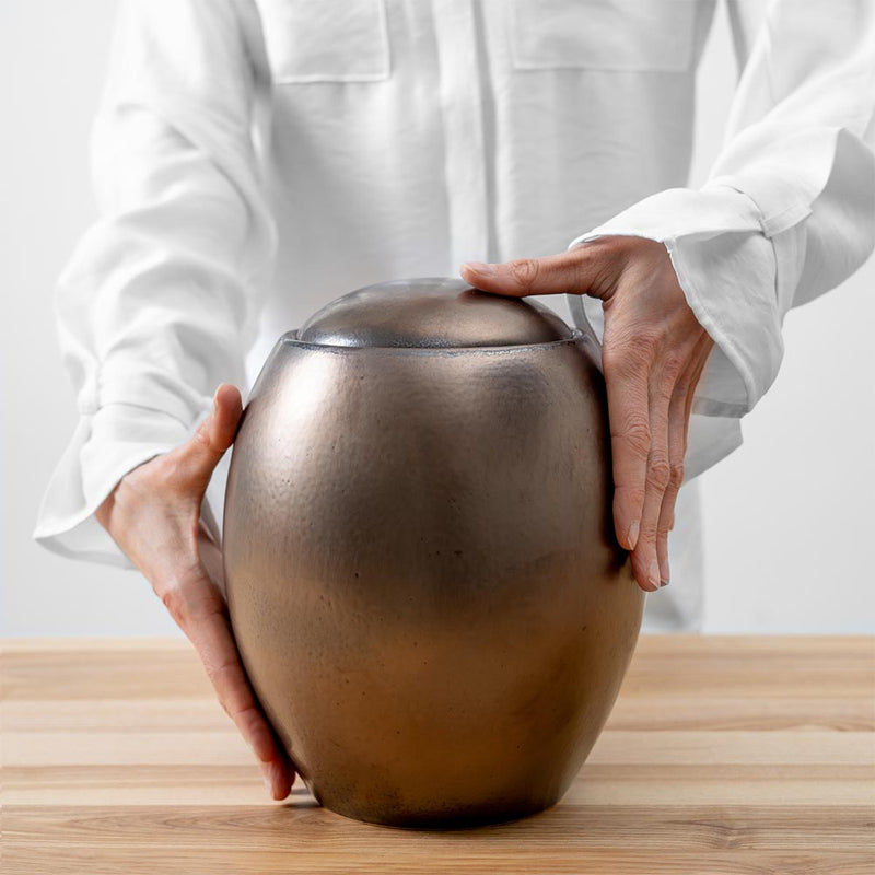 Gold Modern Cremation Urn for Ashes Being Held