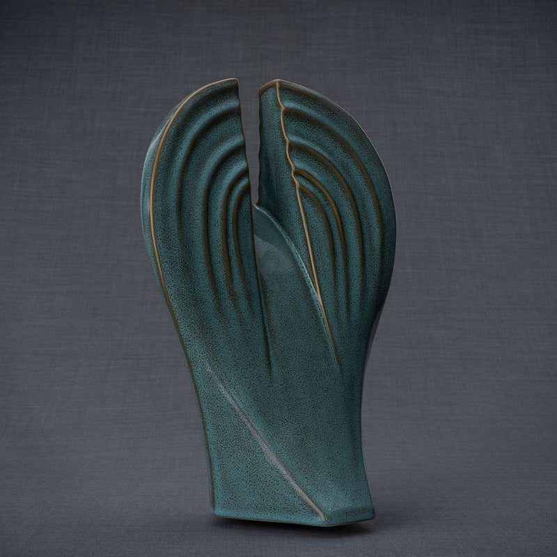 Guardian Cremation Urn for Ashes in Oily Green Facing Behind Grey Background