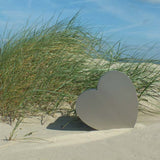 Heart Ashes Miniature Keepsake Urn in Stainless Steel on Sand