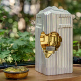 Heart Cremation Urn for Ashes Pearlescent White and Gold Outside on Table