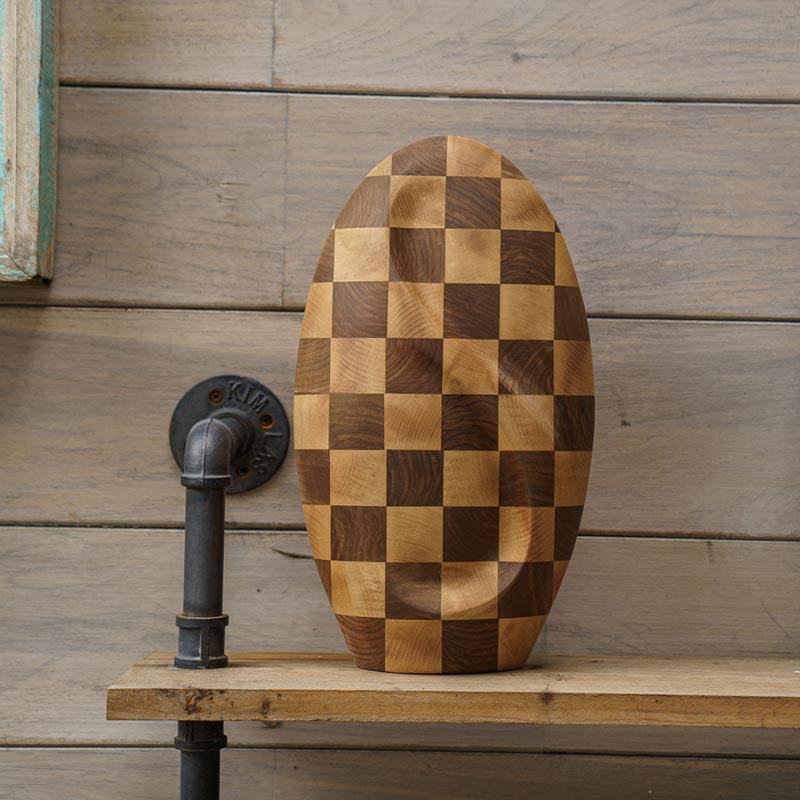 Infinity Wooden Adult Urn for Ashes Chequered Walnut and Beech Wood on Table by Wall
