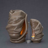 Light Cremation Urn and Ashes Keepsake Urn in Dark Beige Turned Right with Candle Holder Dark Background