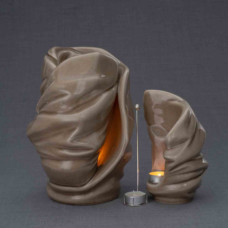 Light Cremation Urn and Ashes Keepsake Urn in Dark Beige Turned Right with Candle Holder Dark Background